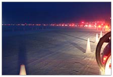 Monday evening, I reached the turn off the paved road just before dark. About 90 minutes later, I was halfway to the gate. The green light glowing just off the left of the pic is the main entrance to the burning man project. The line is four lanes wide!