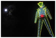 The full moon glowed in the night, while the neon lights of the man shined the way to the evolutionary hub of the Black Rock City playa.