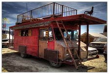 The Suck and Fuck Saloon parked for the day, resting until the evening when it cruises the playa, full of people in the back of what once was an old bread truck. 