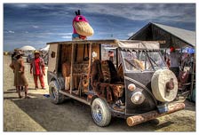 The owner was having some issues with a dead battery. Some eager helper from brought over a spare 12v car battery, but luckily there was enough VW bus owners around to say WHOA there fella, this is a 6v Dino bus. Totally tricked out custom. Beautiful. The log bumper is my favorite.